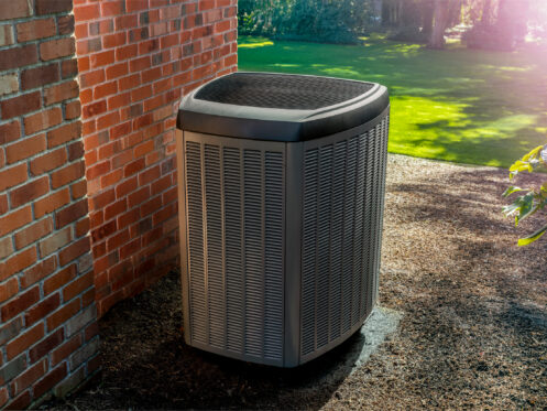 Heat pump outside of a brick home