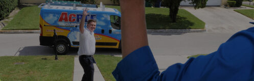 Acree Plumbing technician waving to a happy customer