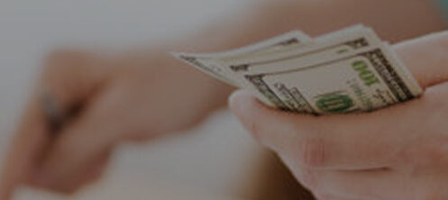 Person holding and counting money