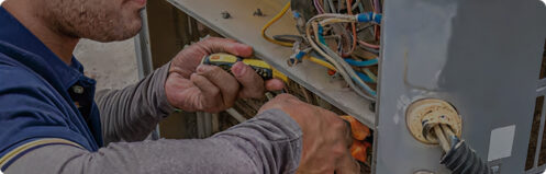 HVAC technician repairing an AC unit in Tampa Florida