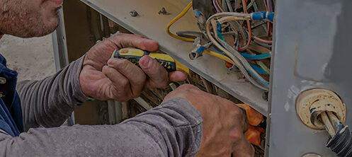 HVAC technician repairing an AC unit in Tampa Florida