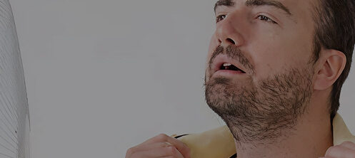 Man spreading shirt collar to fan himself from the Tampa FL heat and humidity