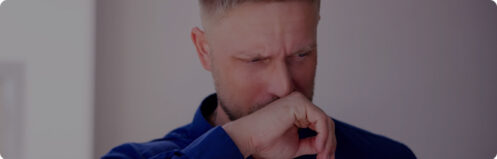 Man covering his face because his HVAC smells weird