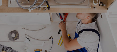 Plumber working on a residential sink