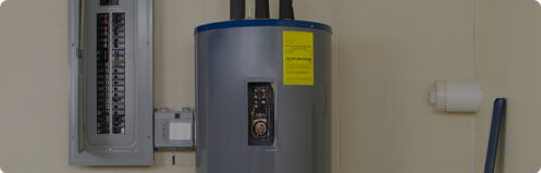 Water heater in the basement next to an electrical panel