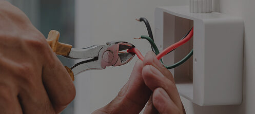 Electrician repairing wires in an outlet