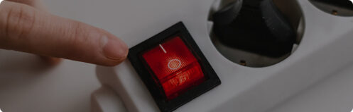 Someone turning on a power strip surge protector