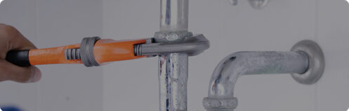 Plumber fixing a residential sink pipe