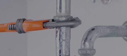 Plumber fixing a residential sink pipe