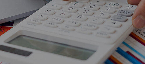Person calculating costs with a calculator