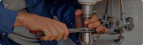 Plumber fixing a sink pipe