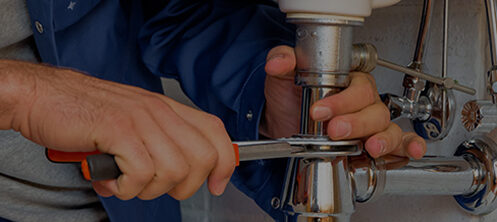 Plumber fixing a sink pipe