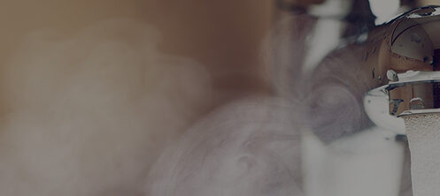 Steaming hot water coming out of a faucet