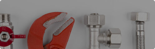 Wrench and screws used for plumbing repair