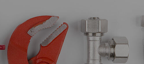 Wrench and screws used for plumbing repair