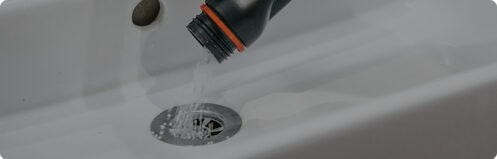 Resident of a home using an at-home drain cleaning solution