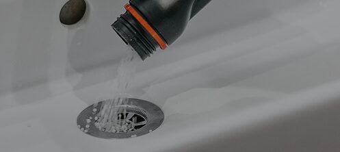 Resident of a home using an at-home drain cleaning solution