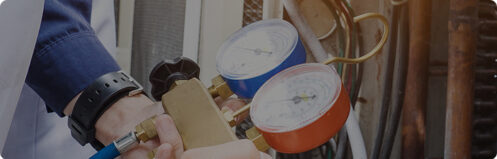 HVAC technician servicing an AC unit