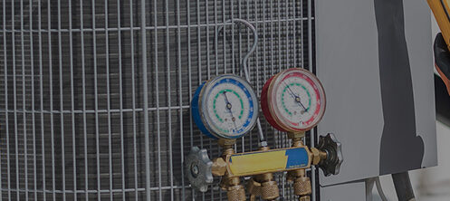 HVAC technician servicing maintenance to an AC unit