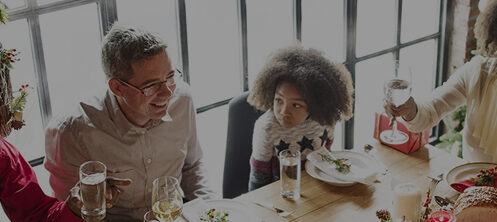 Happy family gathered for a Christmas holiday dinner at a big dining table in Florida