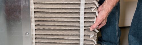 Man changing a furnace filter