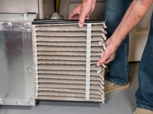 Man changing a furnace filter